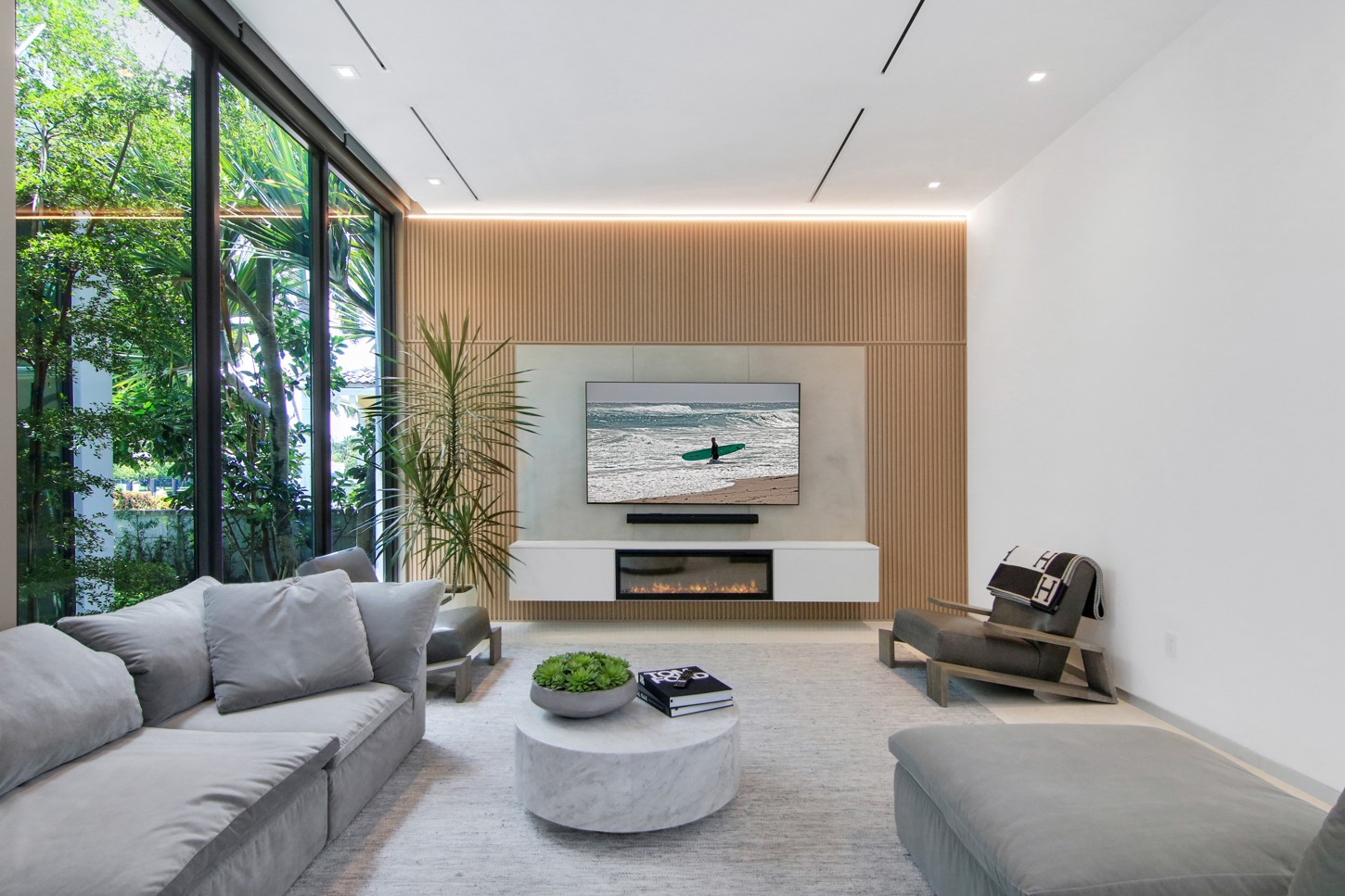 Living room floating TV console with wood slat panels in North Miami