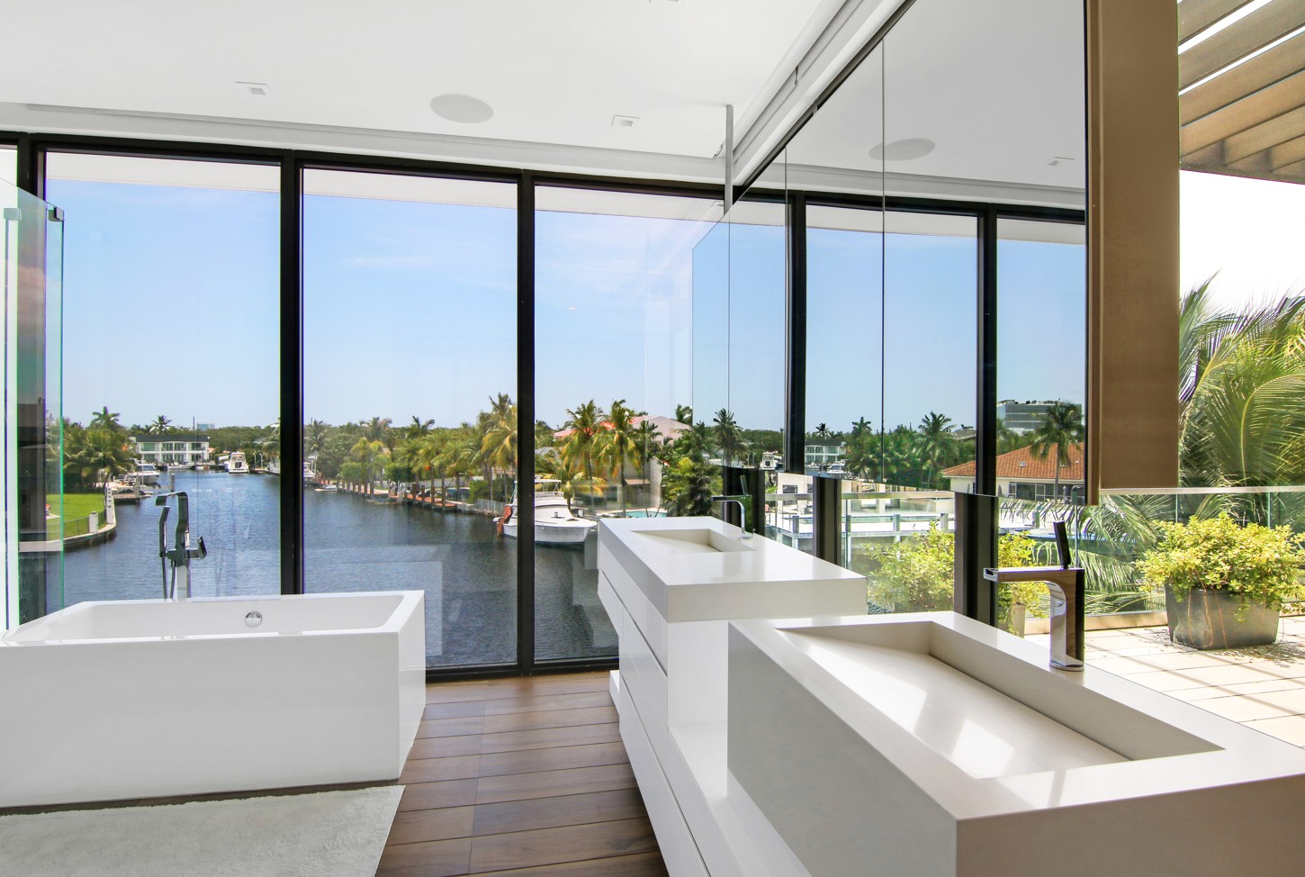 Custom floating vanity with stone sinks in a North Miami master bathroom