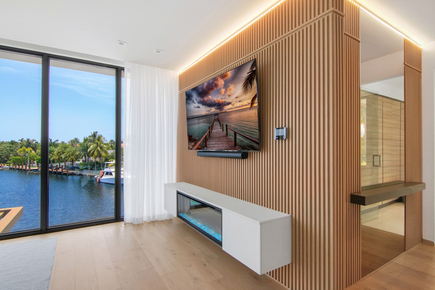 Master bedroom wood slat wall panels with a floating TV console in North Miami