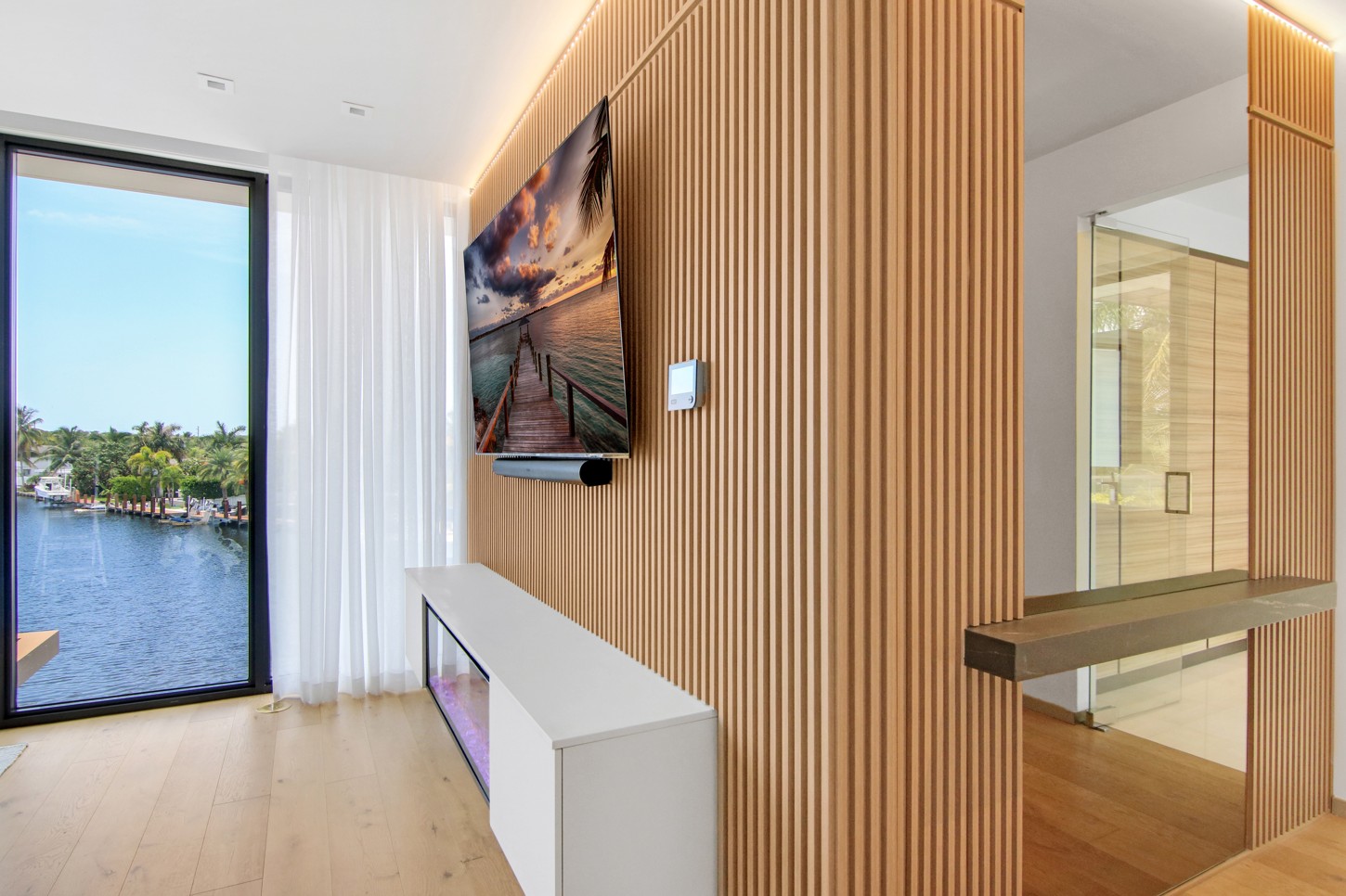 Master bedroom wood slat wall panels with a waterfront view in Eastern Shores