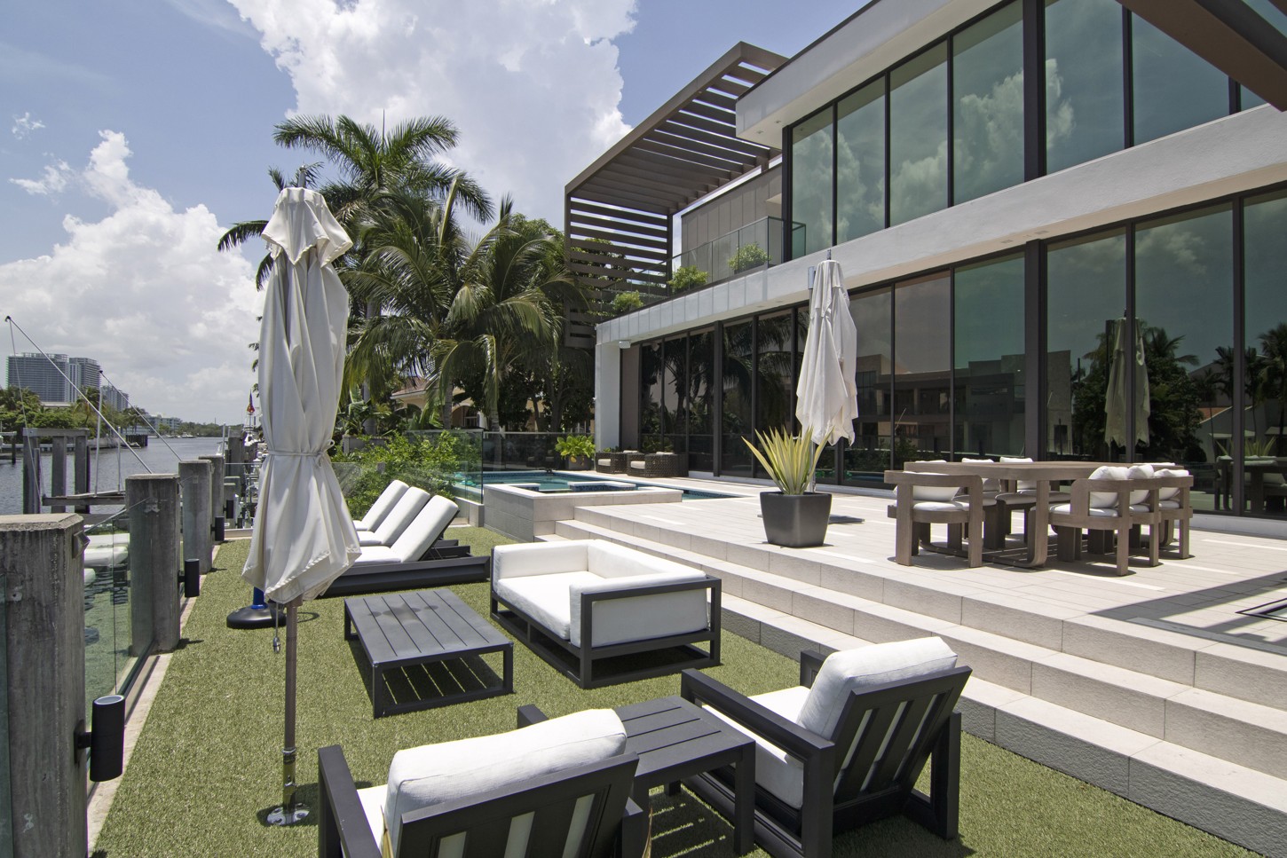 Custom outdoor furniture on a patio at a waterfront home in North Miami