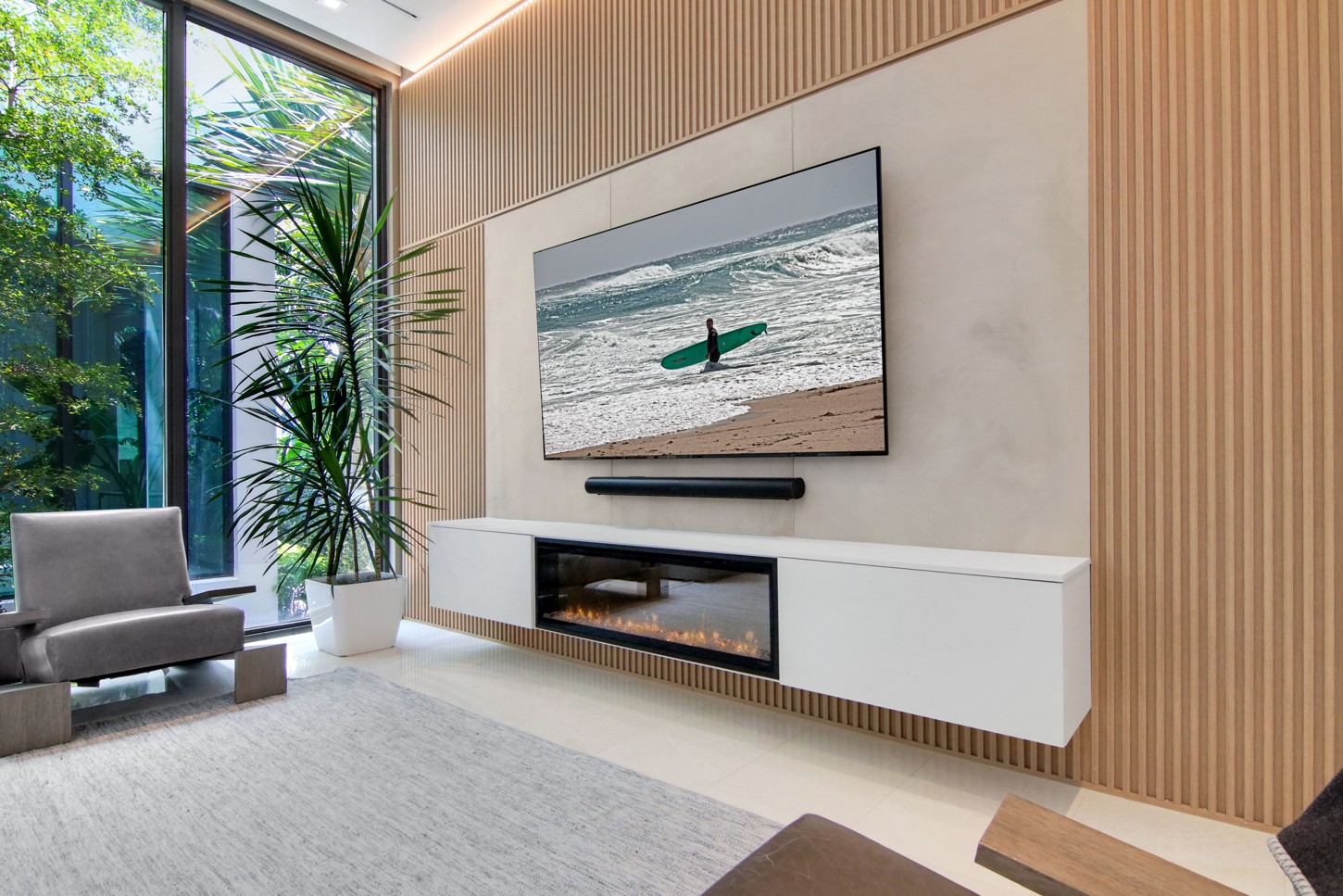 TV wall unit detail with concrete finish and wood slats in North Miami