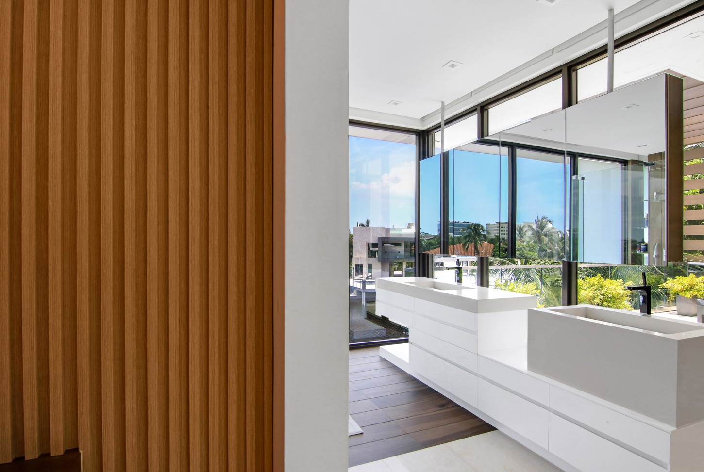 Wood slat panel detail beside the floating vanity in a North Miami master bathroom
