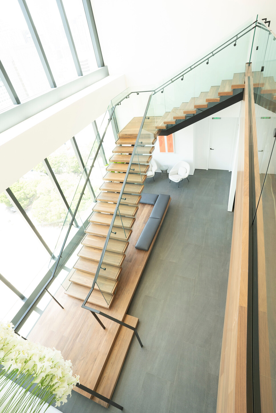 Vertical view of a floating staircase glass railing in a Miami high-rise office