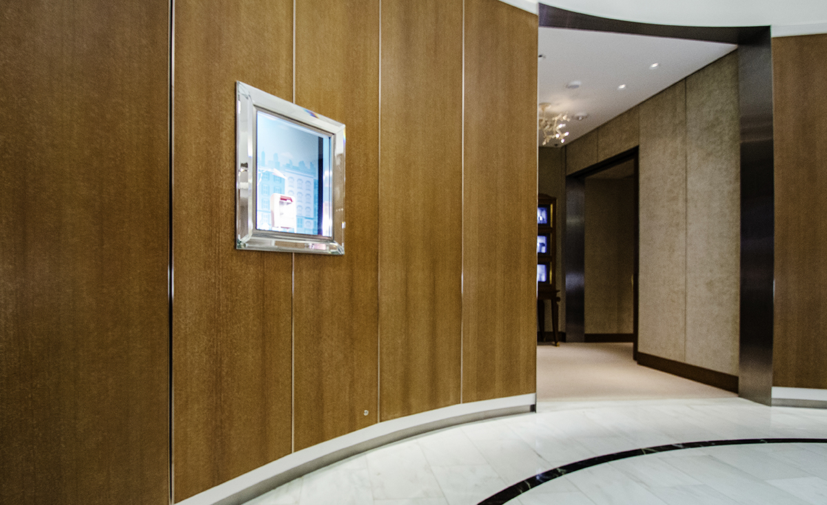 Curved custom wood wall panels with metal reveals inside the Tiffany boutique at Bal Harbour Shops