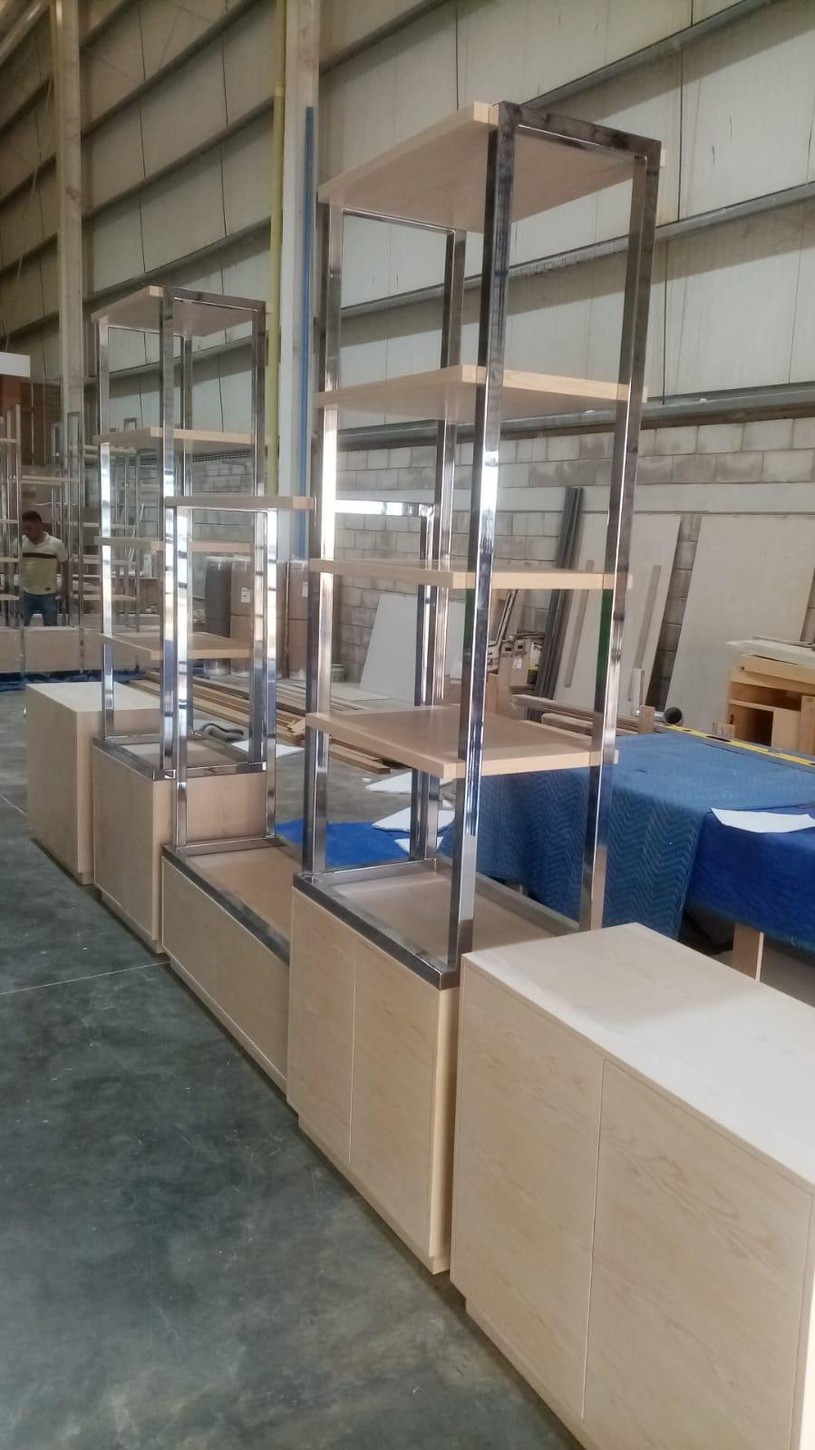 Custom wood veneer and metal display units in the CM Custom Design fabrication shop before delivery