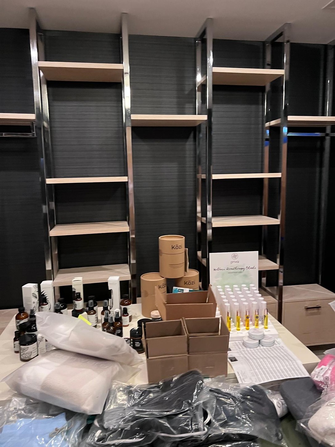 Custom wood veneer shelving with polished metal frames for spa product display