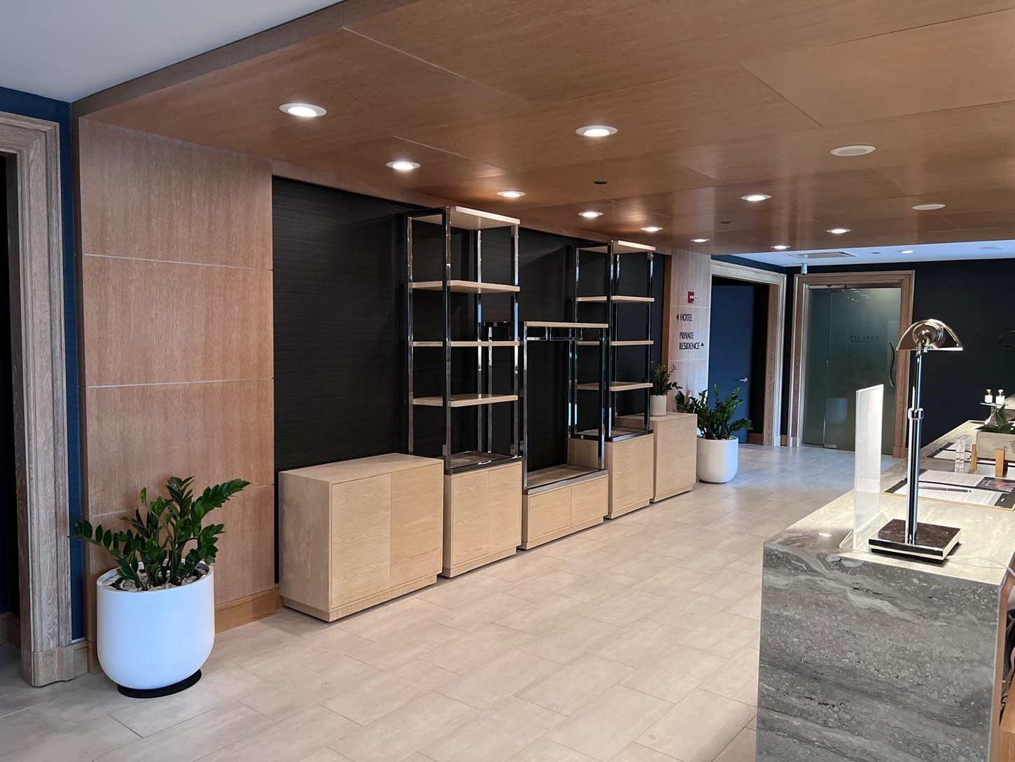 Spa reception area with custom wood veneer and metal frame display millwork at Trump International Hotel & Tower Chicago