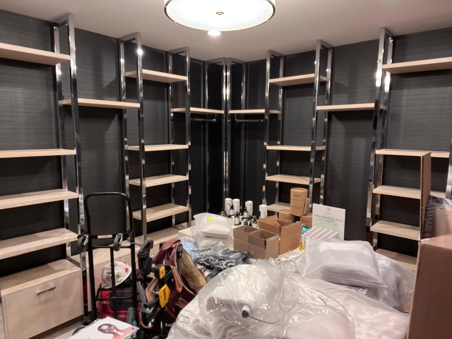 Spa storage room with custom wood veneer shelving and metal frames