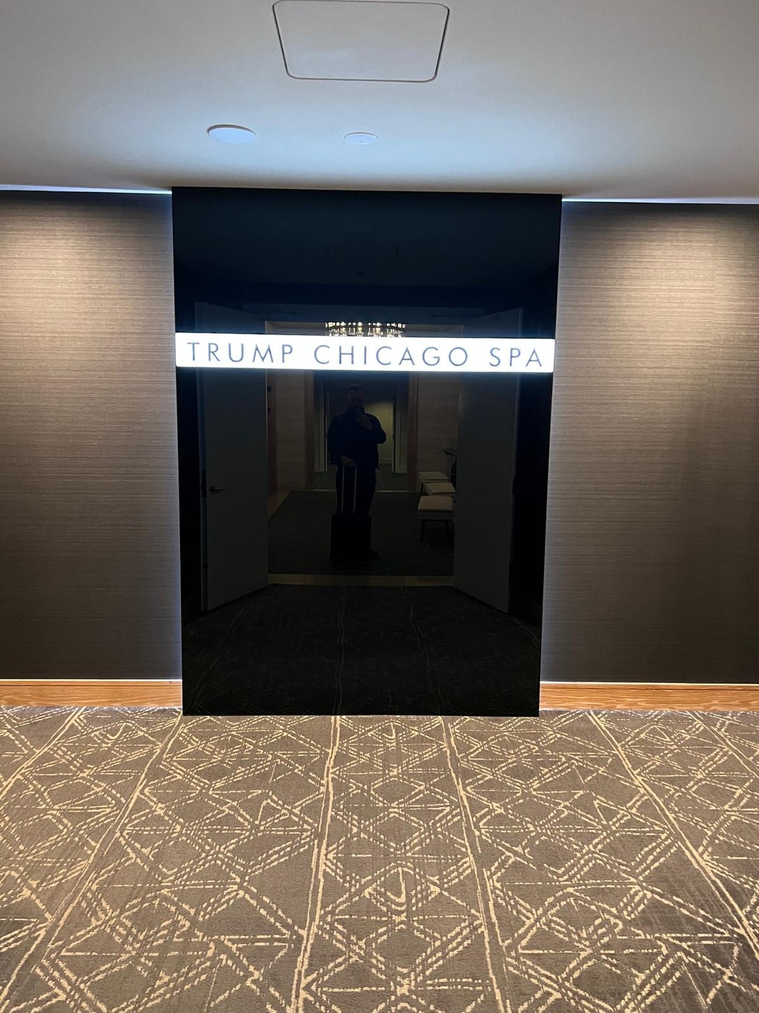 Trump Chicago Spa entrance with black glass signage in the hotel corridor