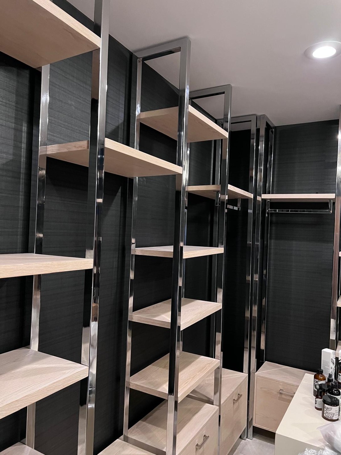 Wood veneer shelving with polished metal frame in a spa room, Trump Chicago
