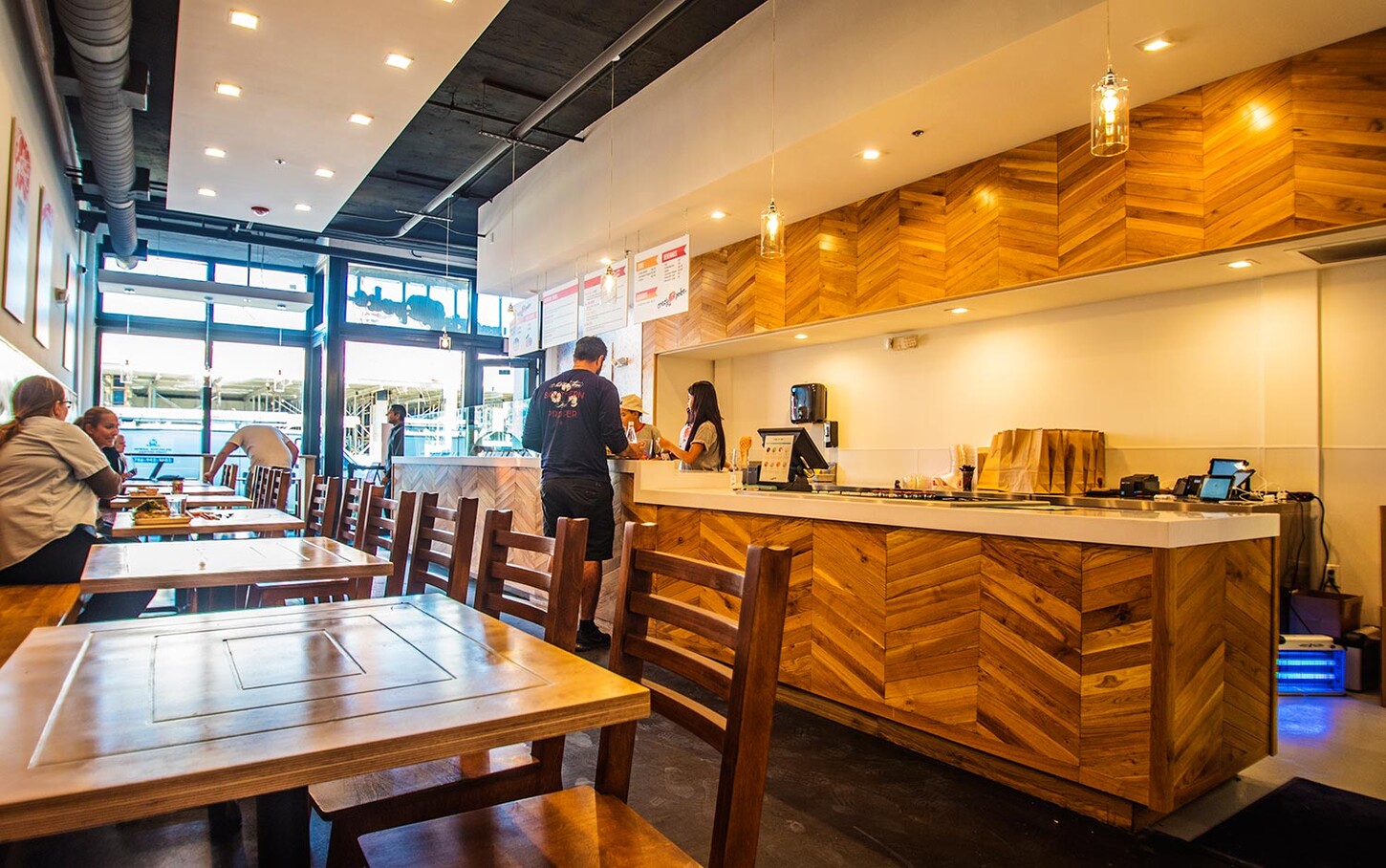 Crazy Poke Wynwood restaurant millwork project by CM Custom Design, with custom chevron wood service counter