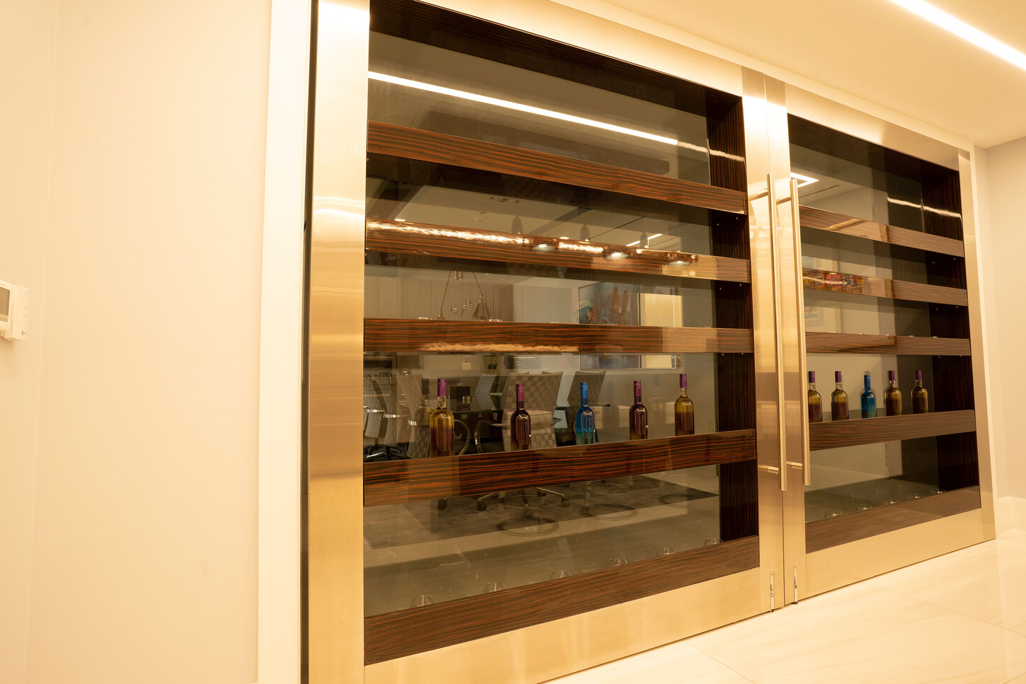 Custom glass-door display cabinet with wood shelving at the Zarco law firm in Florida