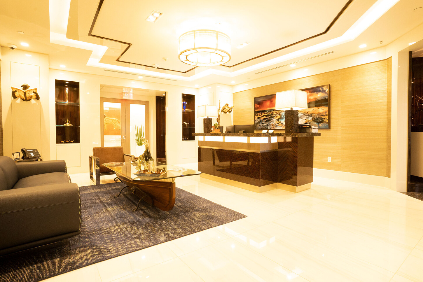 Custom reception desk millwork and wood wall paneling at the Zarco law firm in Florida
