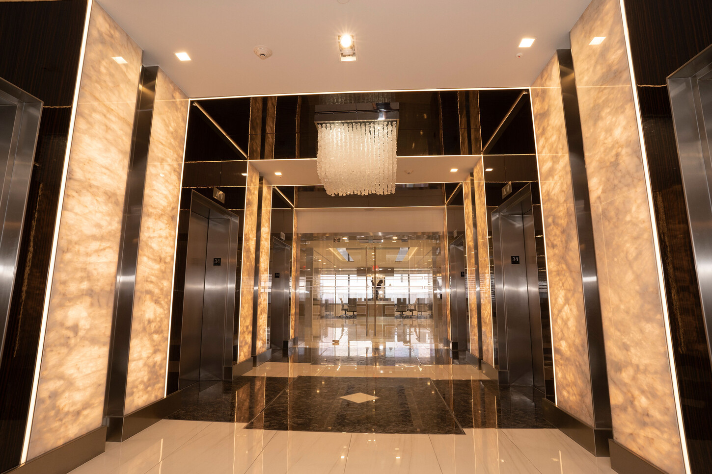 Elevator corridor with illuminated onyx panels at the Zarco law firm in Florida