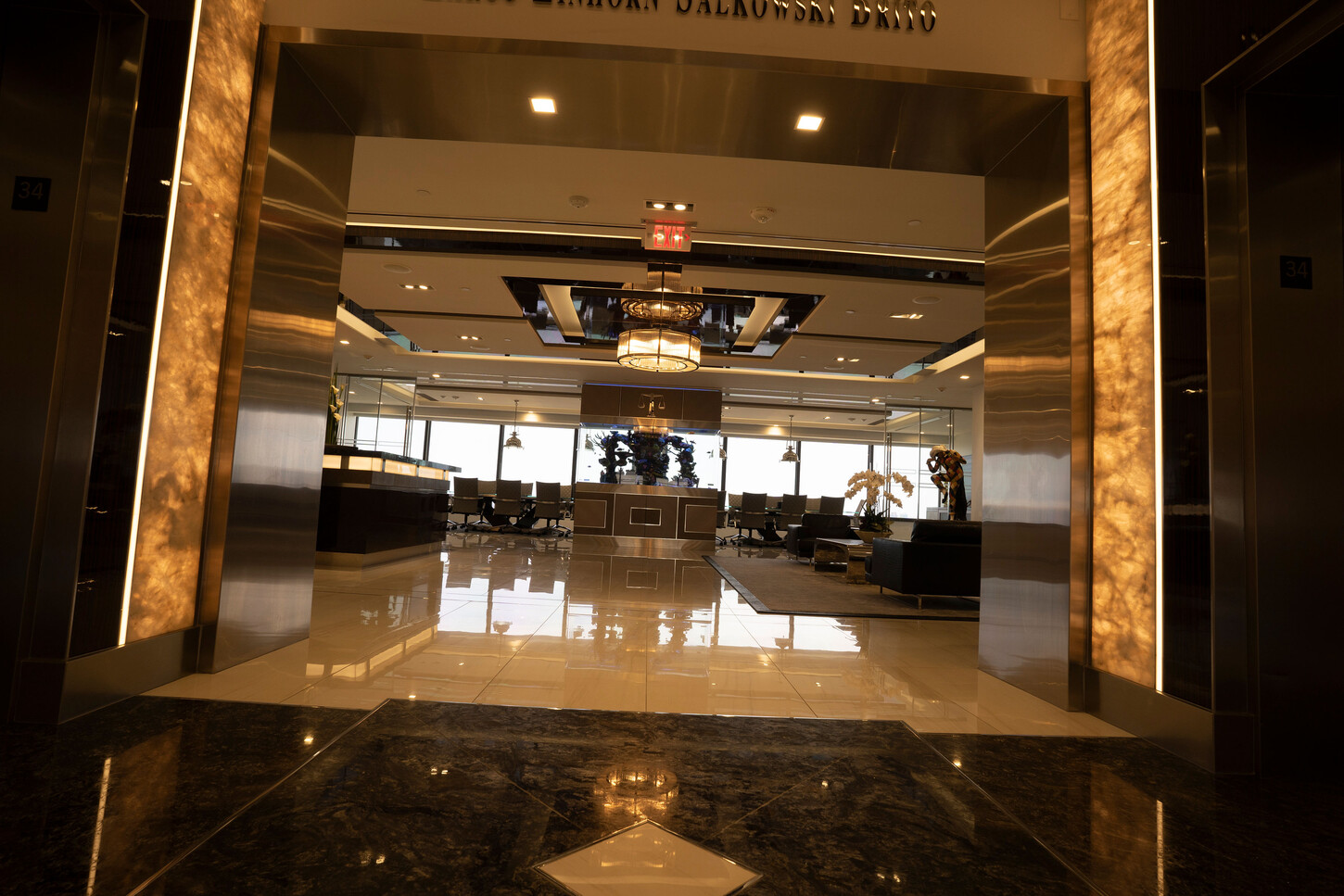Onyx wall panels in a softly lit elevator lobby at the Zarco law firm in Florida