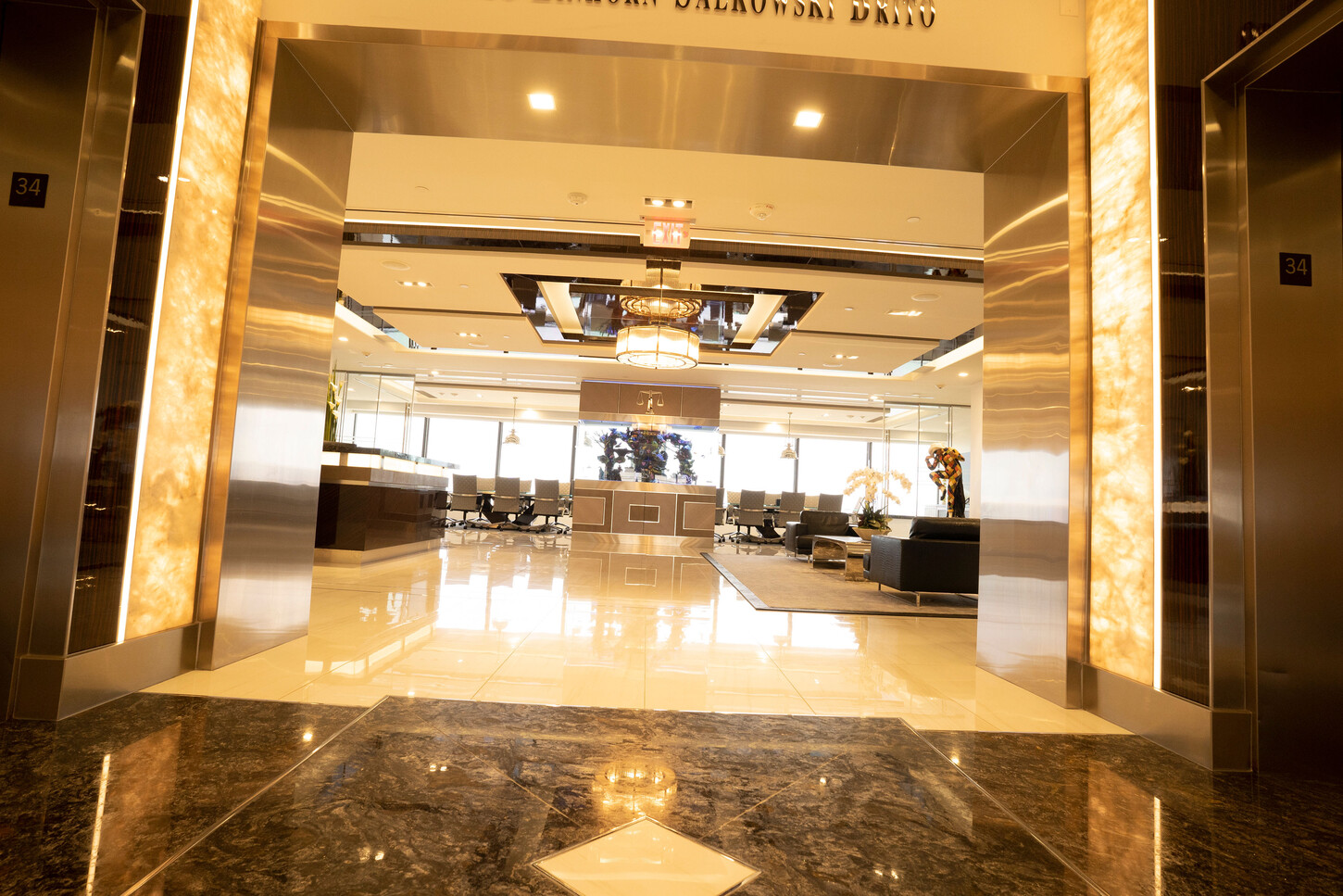 Backlit onyx elevator entrance in the lobby of the Zarco law firm in Florida