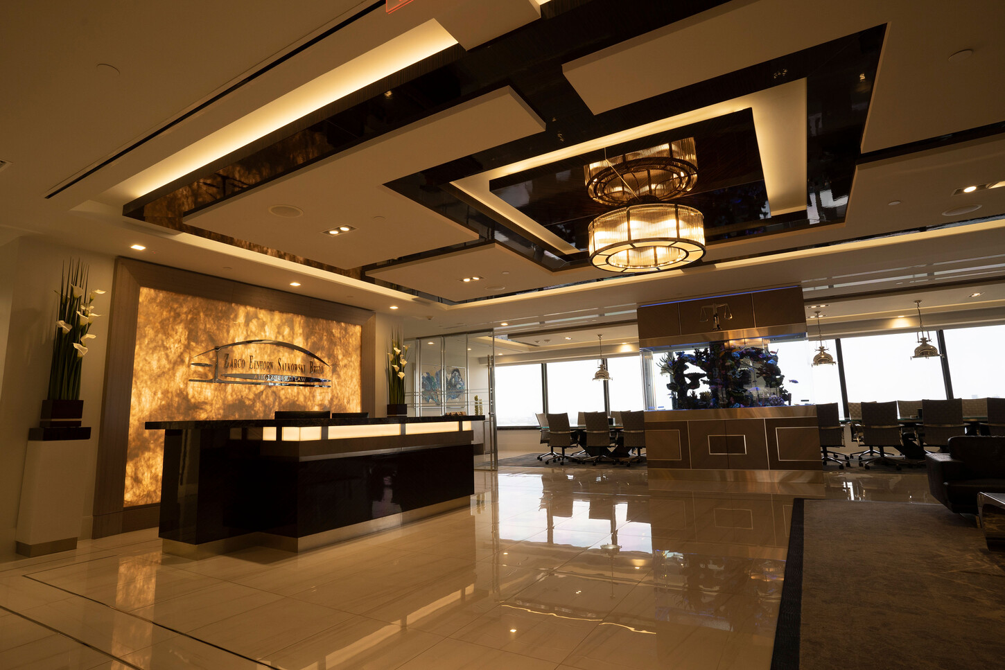 Luxury reception desk with an onyx wall and coffered ceiling at the Zarco law firm in Florida