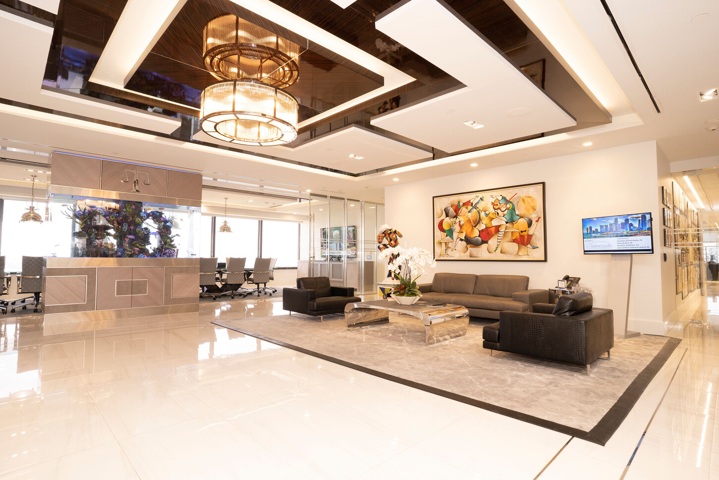 Main lobby with a coffered ceiling, chandeliers and lounge seating at the Zarco law firm in Florida