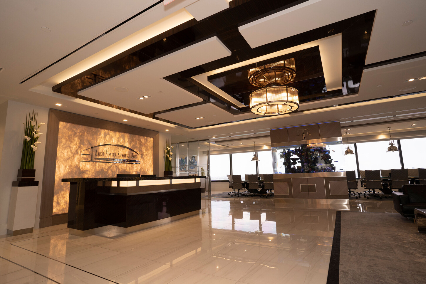 Reception desk in front of a backlit onyx feature wall at the Zarco law firm in Florida